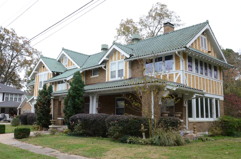 The historic Eagle House in Lonoke, a Craftsman home with a green tile roof.